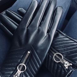 Midsection of person wearing leather gloves