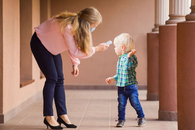 Full length side view of two women walking outdoors