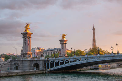 View of bridge over river against cloudy sky