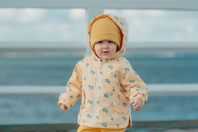 Portrait of cute girl standing at beach