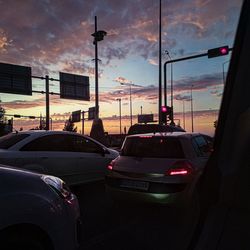 Traffic on road at sunset
