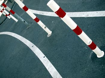 High angle view of bollards and road markings on street