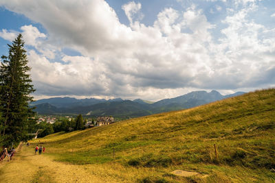 Scenic view of field and mountains against sky