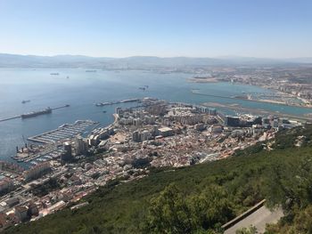 High angle view of townscape by sea against sky