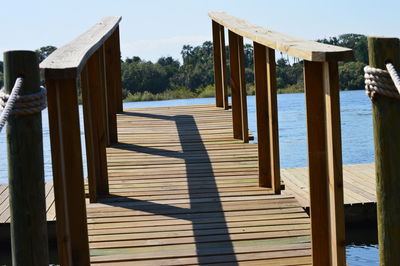 Wooden posts on beach against sky