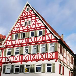 Low angle view of red building against sky