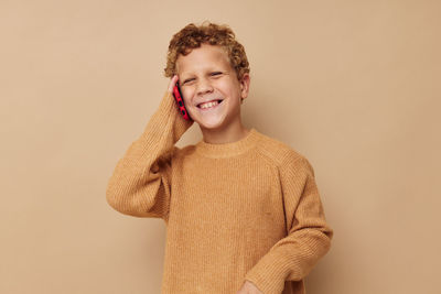 Portrait of smiling boy talking on phone