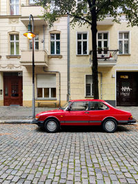 Car on street against buildings in city