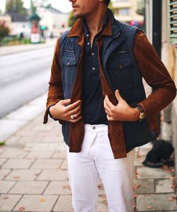 Midsection of young man standing at sidewalk