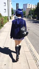 Rear view of woman walking on street