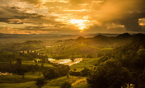 Scenic view of landscape against sky during sunset