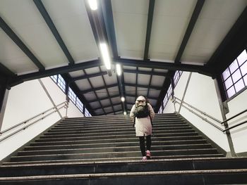 Low angle view of woman walking on staircase