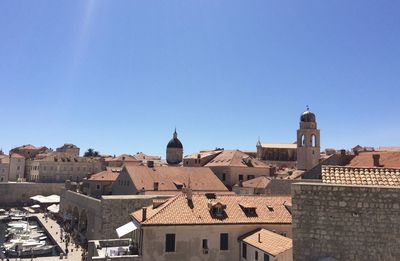 Buildings in city against blue sky