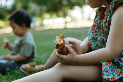 Midsection of baby eating food at garden