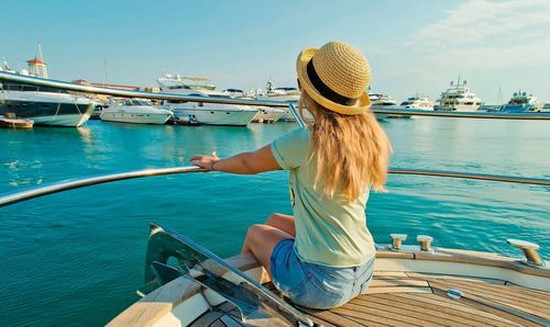 Woman sitting on boat sailing in sea