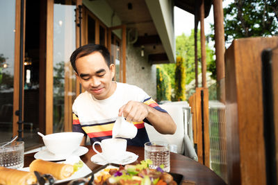 Mid adult man sitting at restaurant table