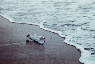 High angle view of bottle on beach