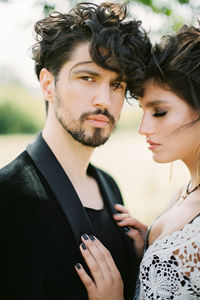 Portrait of smiling couple standing outdoors