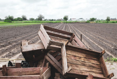 Pile of wooden crates on a farm field. end of potato planting campaign. agroindustry. farm 