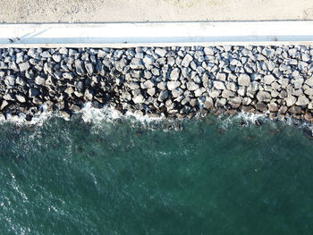 High angle view of stones by sea