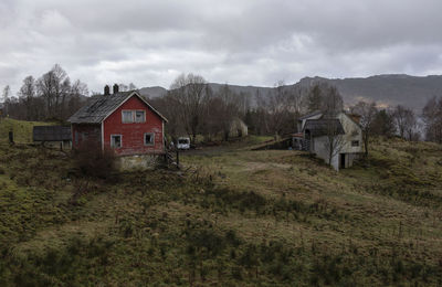 Houses on field against sky