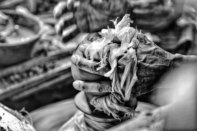 Close-up of person working on pottery wheel