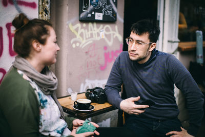 Young couple sitting on table at restaurant