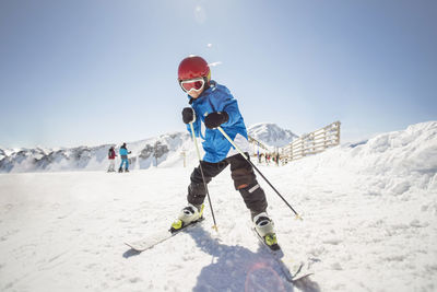 Full length of man skiing on mountain against sky