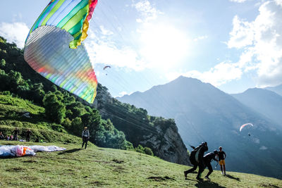 People paragliding on mountain