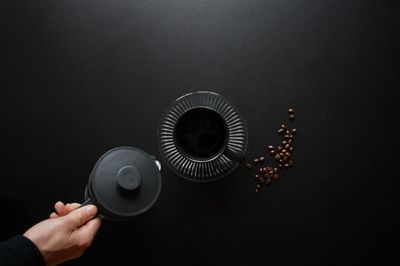 Midsection of person holding painting against sky