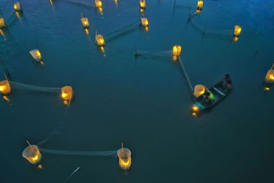 High angle view of illuminated floating on sea