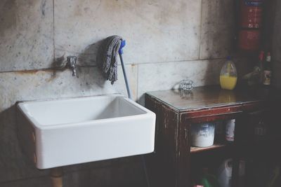 Sink and mop in bathroom