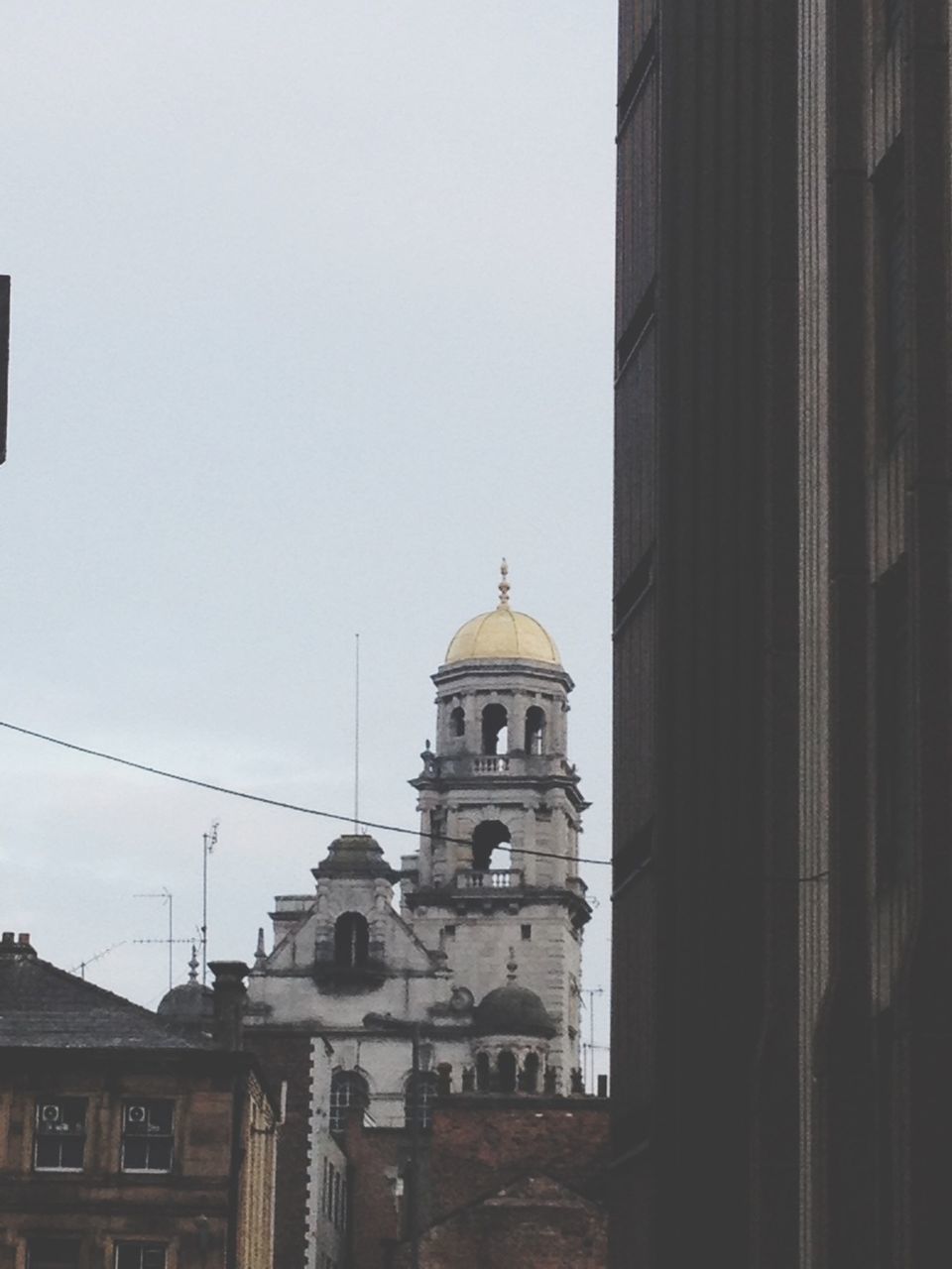 building exterior, architecture, built structure, church, place of worship, religion, low angle view, clear sky, spirituality, dome, city, high section, building, copy space, sky, window, tower, outdoors