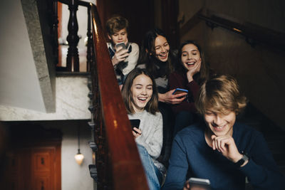 Portrait of smiling young woman using smart phone
