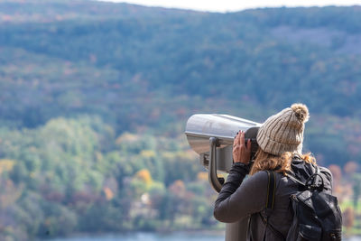 Woman looking at camera against mountain