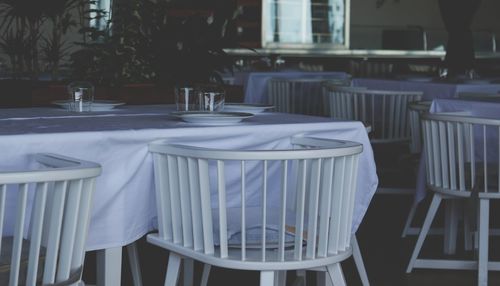 Empty chairs and tables in restaurant