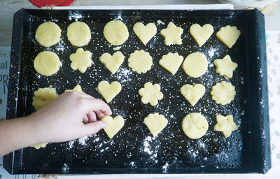 High angle view of hand holding cookies