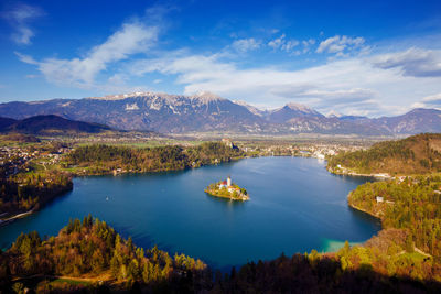 Scenic view of lake and mountains against blue sky