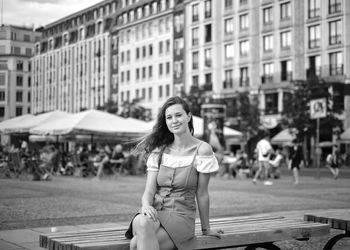 Portrait of smiling young woman sitting outdoors