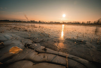 Scenic view of lake against sky during sunset