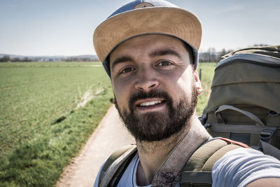 Portrait of man smiling on field