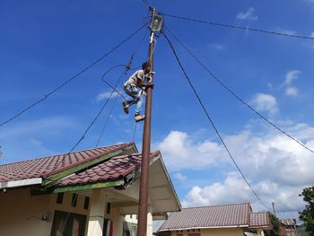 Low angle view of roof and houses against sky