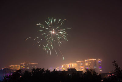 Low angle view of firework display at night