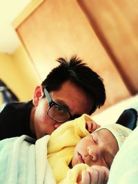 Portrait of man with baby boy at home