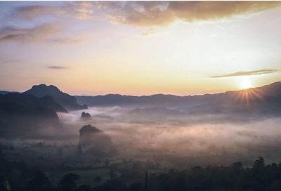 Scenic view of silhouette mountains against sky during sunset