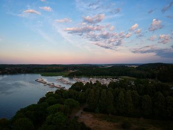 High angle view of river and trees against sky at sunset