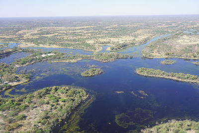 High angle view of lake and landscape against sky