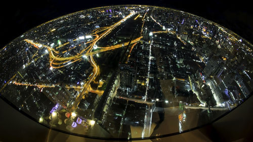 High angle view of illuminated modern buildings in city at night