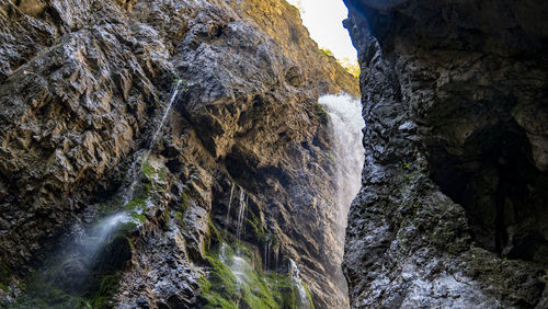 Low angle view of waterfall on rock formation