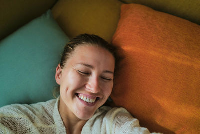 Portrait of young woman sleeping on sofa at home